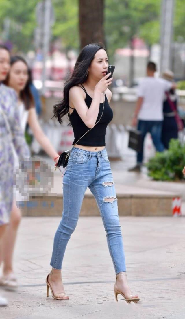 吊带|街拍：长发披肩的美女，牛仔裤搭配吊带背心，帅气中带有几分时尚魅力
